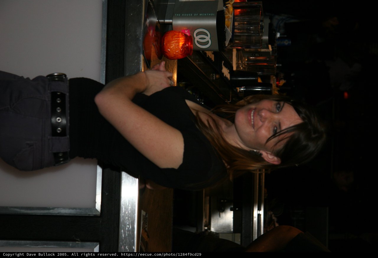 Woman Smiling at Bar Counter Late Night