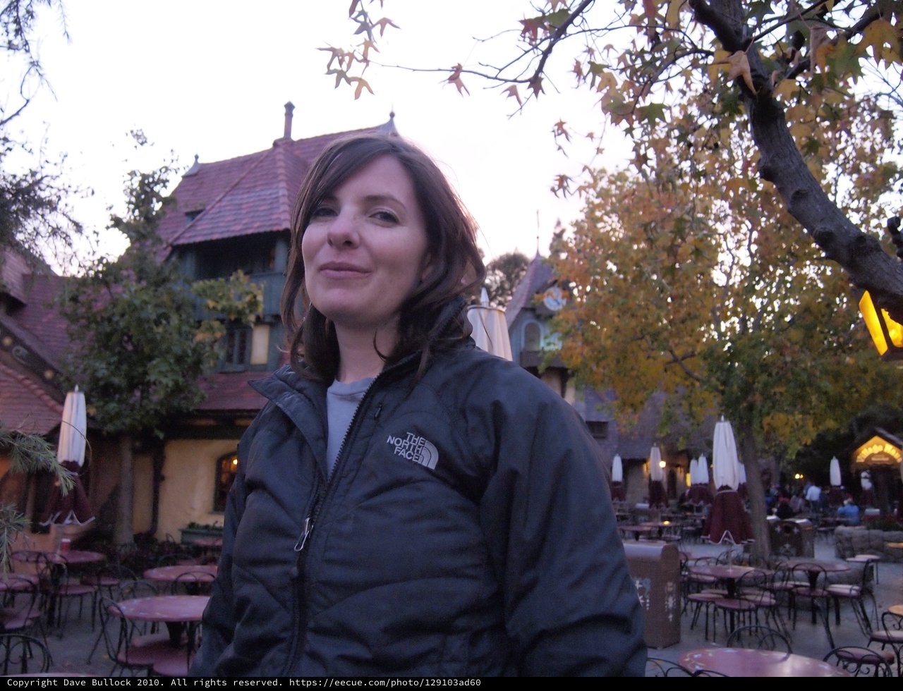 Woman in North Face Jacket at Twilight Courtyard