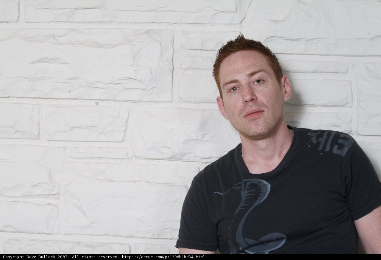 Black Shirt Portrait Against White Wall