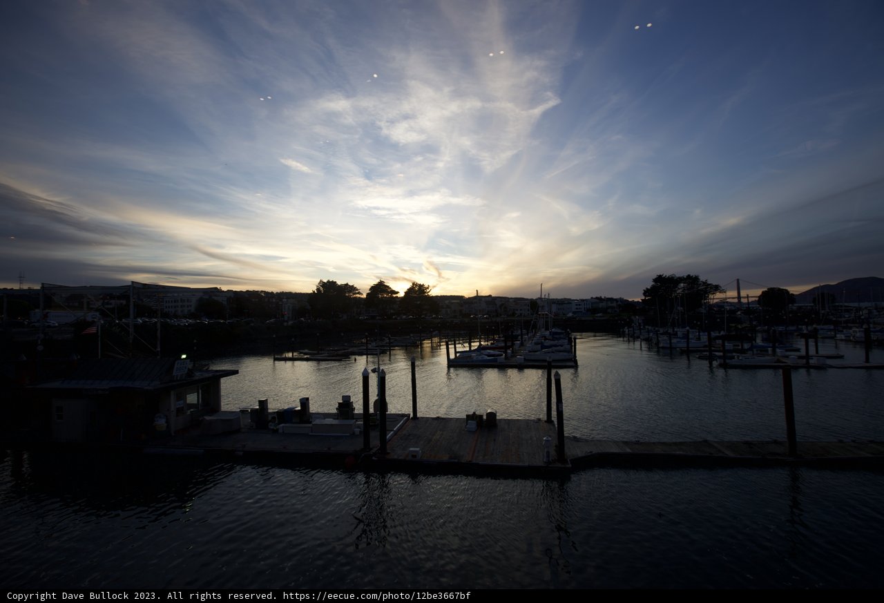 Tranquil Tides: Dock At Dusk Showcasing Sunset's Symphony