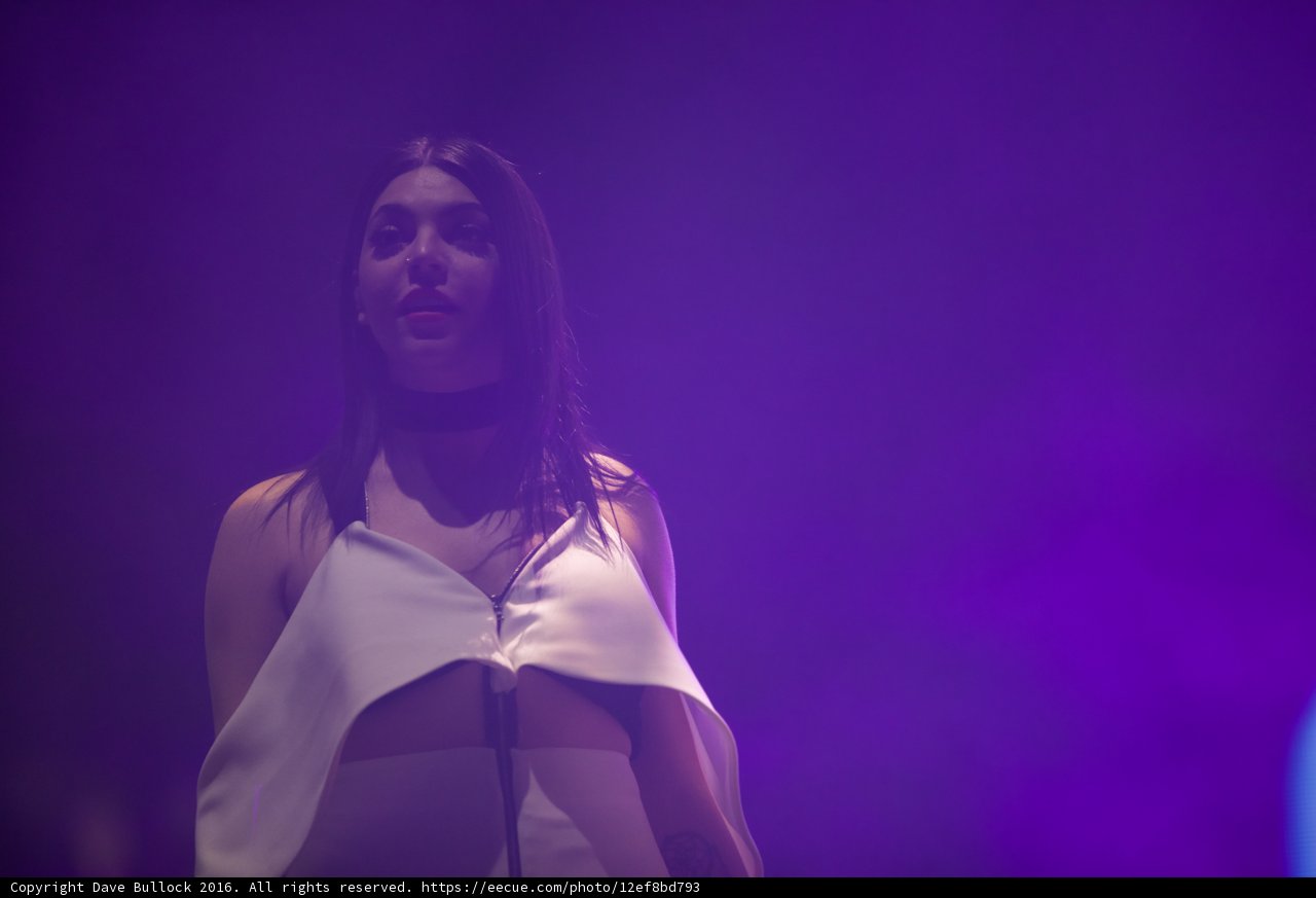 Luminous Lady in White: Perfect Purple Lighting at Coachella
