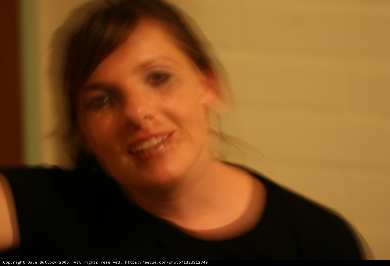 Motion Blur Portrait of Smiling Woman in Warm Light