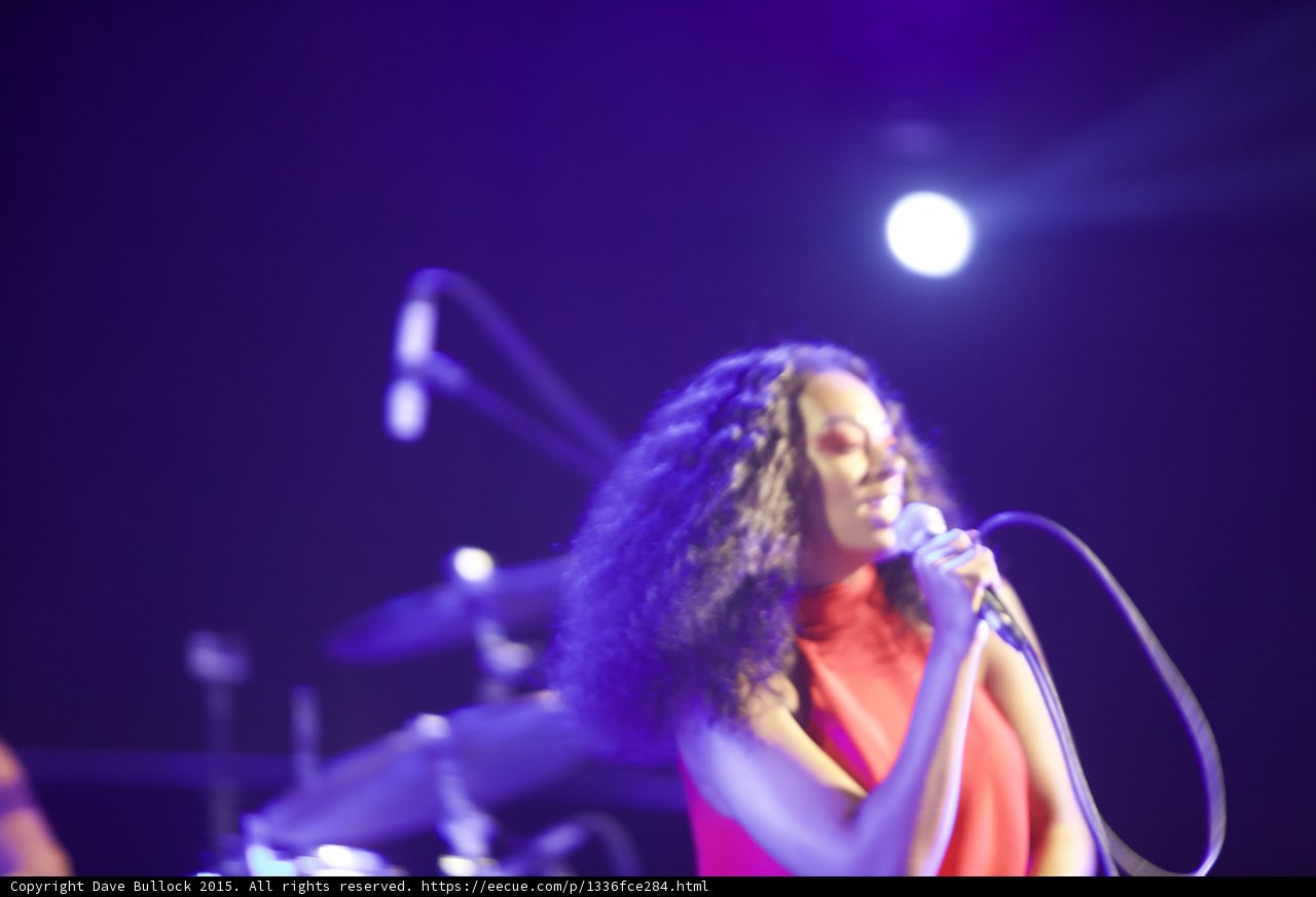 Solange Smiling Softly Microphone Close Spotlight Purple