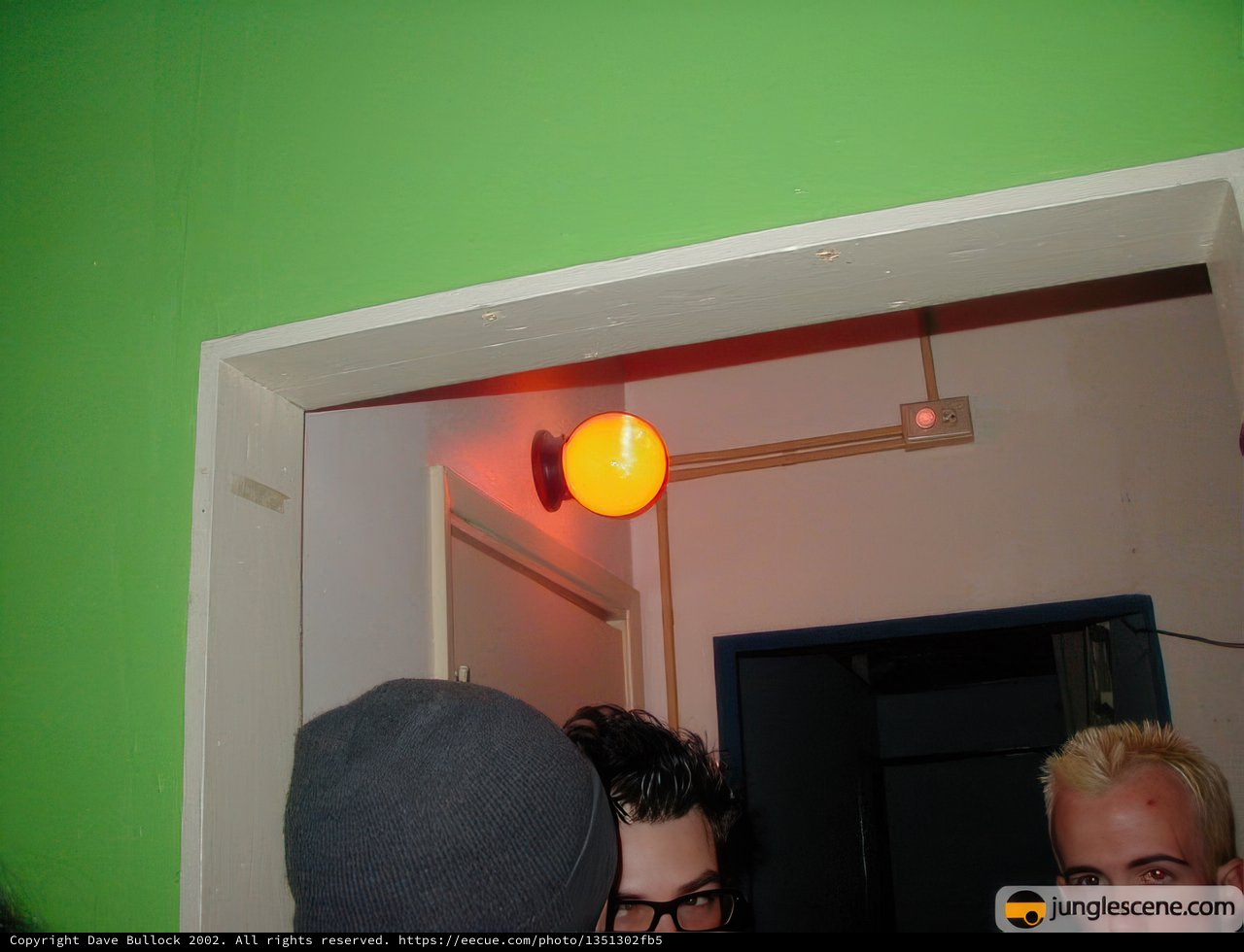 Hat-wearing man in a doorframe