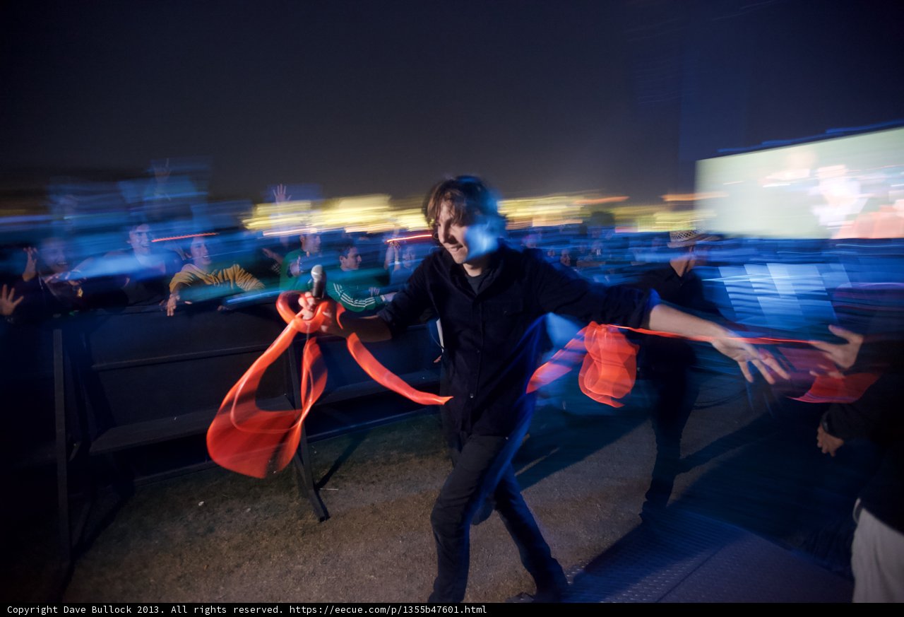 Thomas Mars Holds Red Ribbon in front of Adoring Crowd