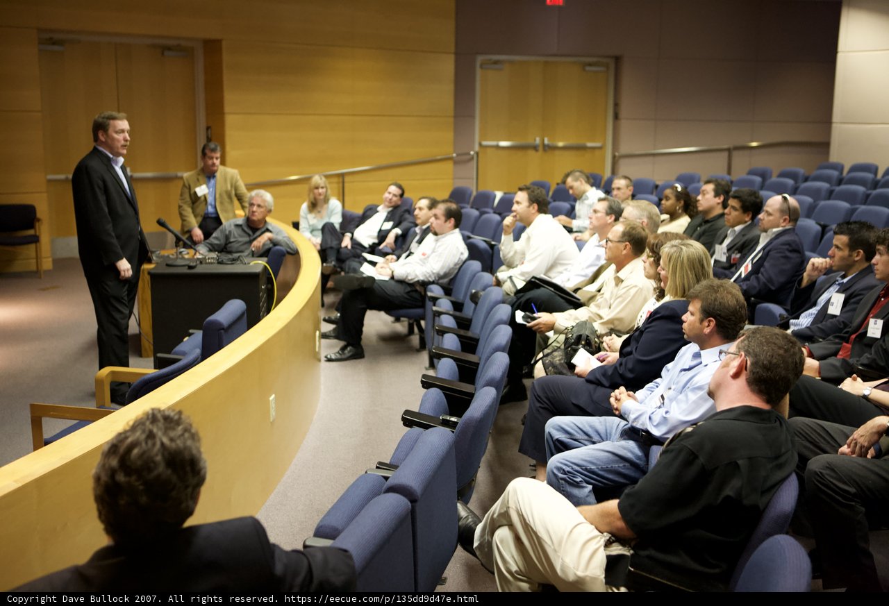 Speaker addressing a crowded auditorium