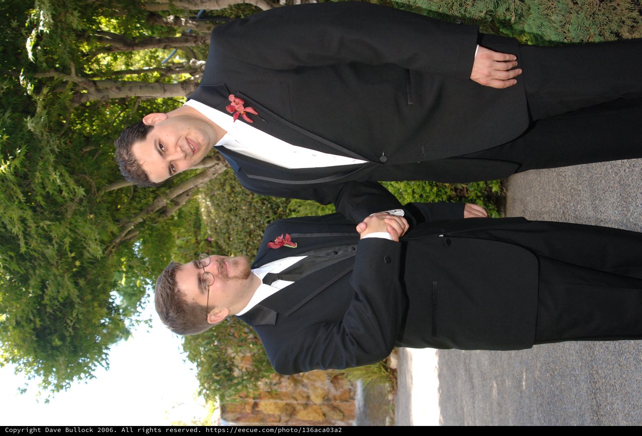 Two Groomsmen Share a Handshake at Wedding