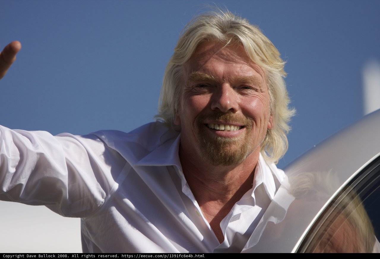 A Happy Richard Branson Waving to the Sky