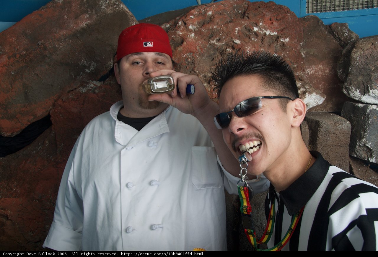 Two Men Enjoying a Snack Outdoors