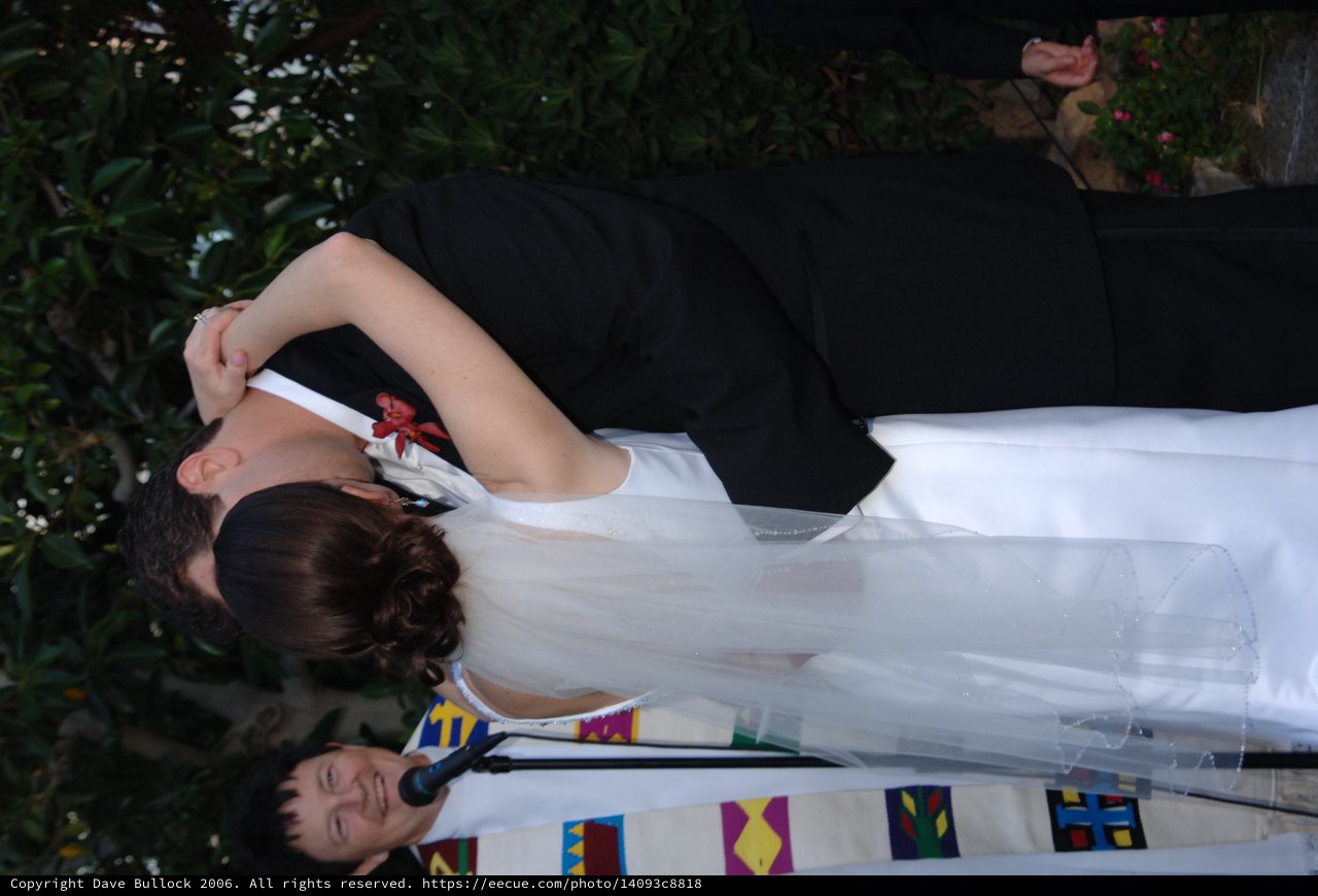 Bride and Groom Share First Kiss at Outdoor Ceremony