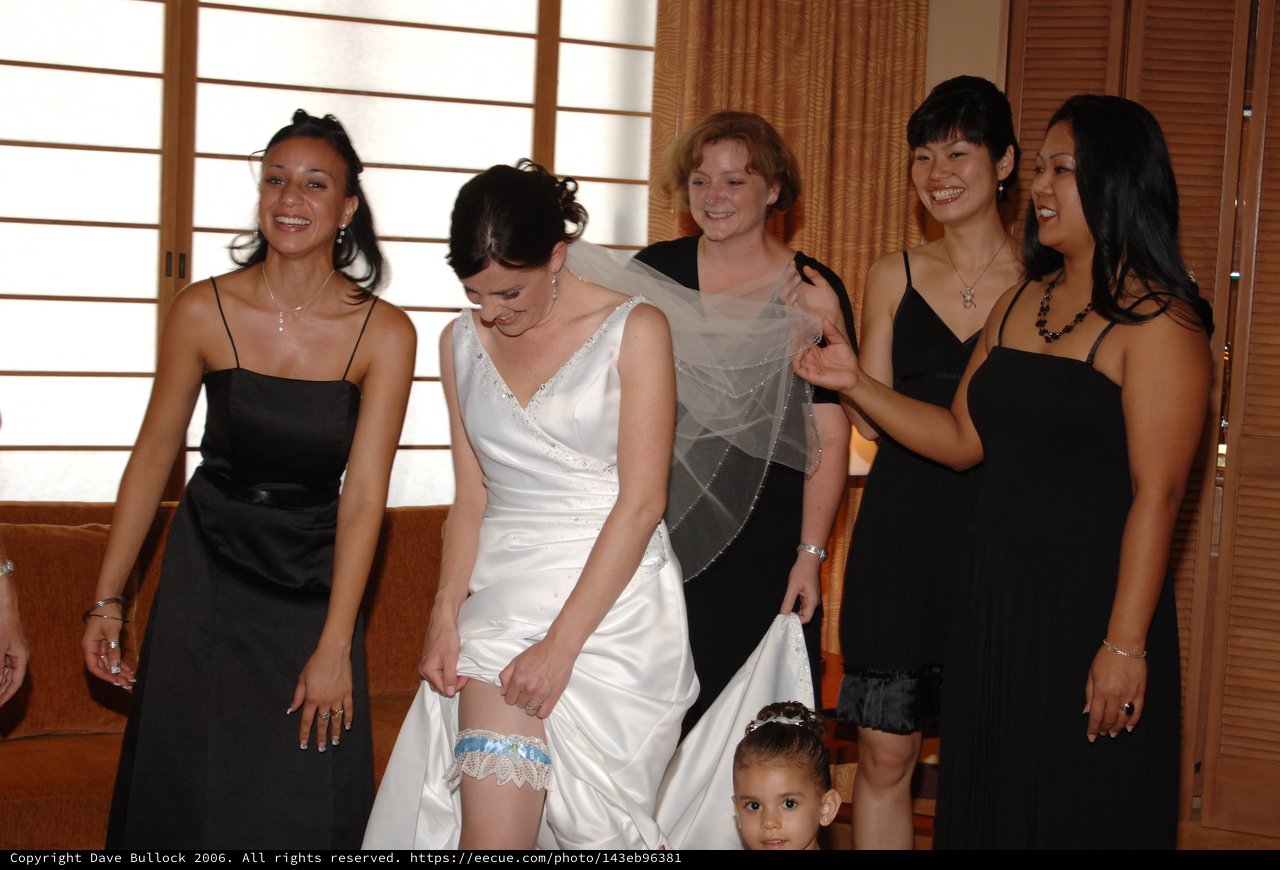 Bride Shows Off Her Garter With Bridesmaids