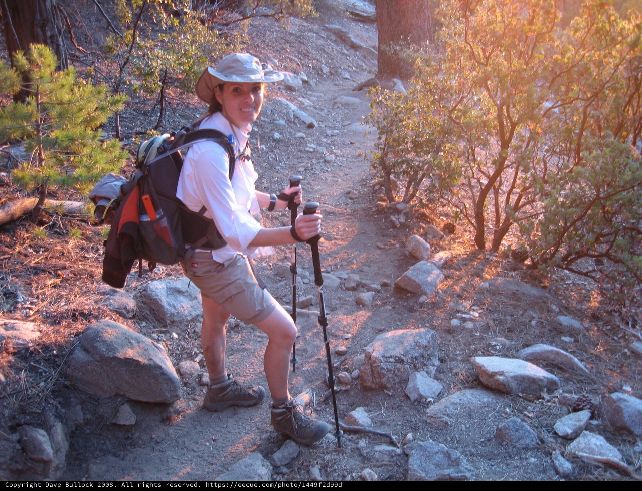 Smiling Hiker on Rocky Mountain Trail at Sunset