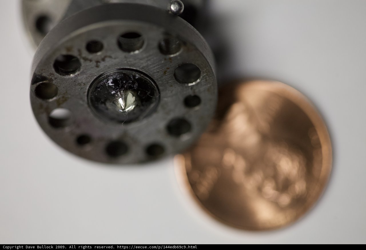 A Penny and a Bronze Object Up Close