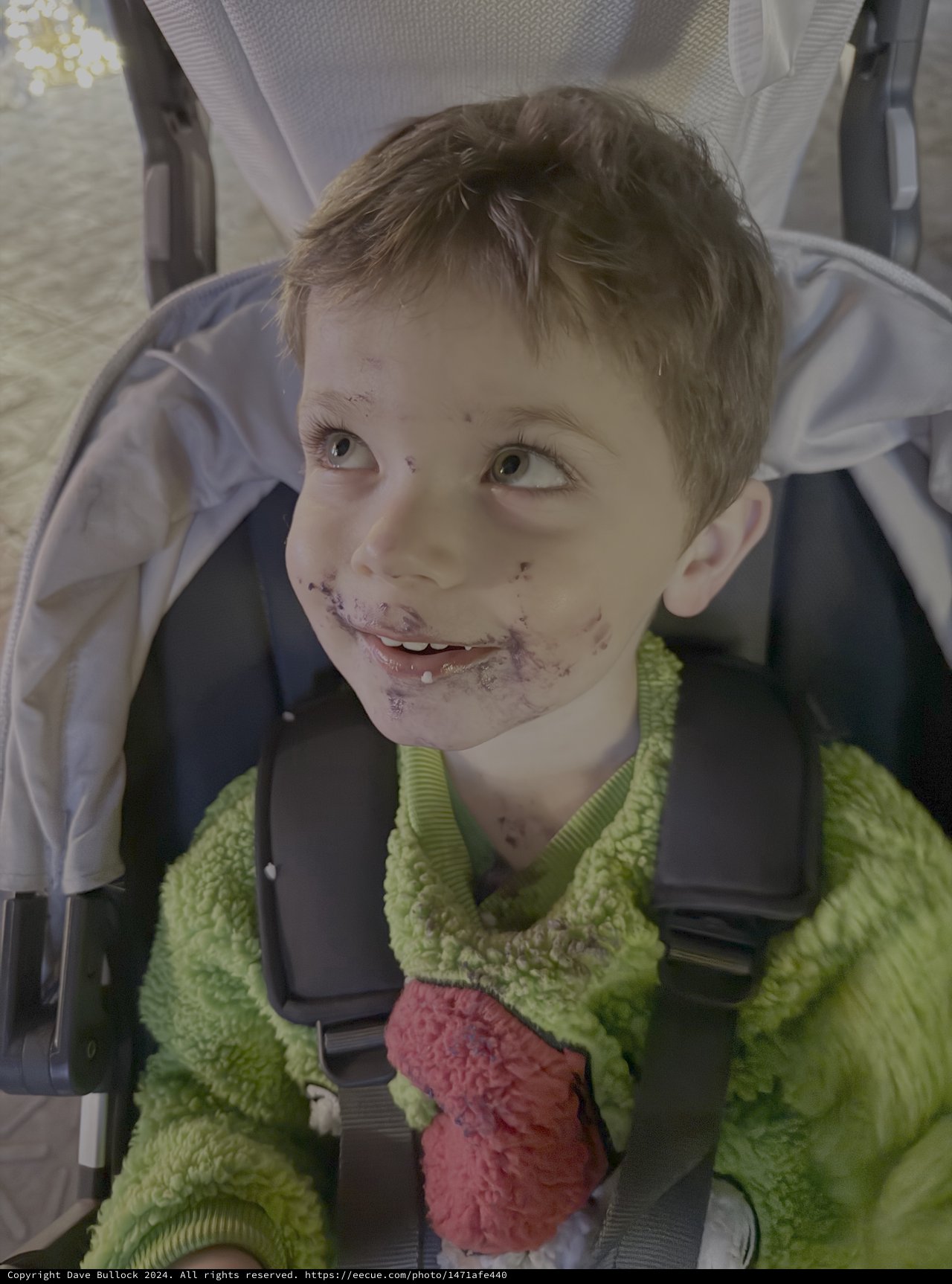 Young Child Enjoying Messy Meal in Stroller