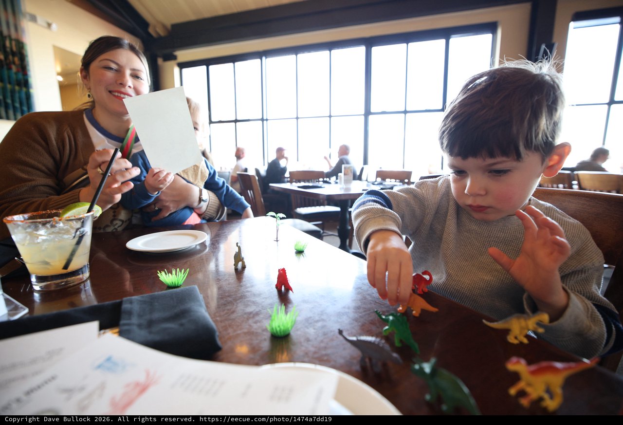 Mother and Child Playing with Toys at Restaurant