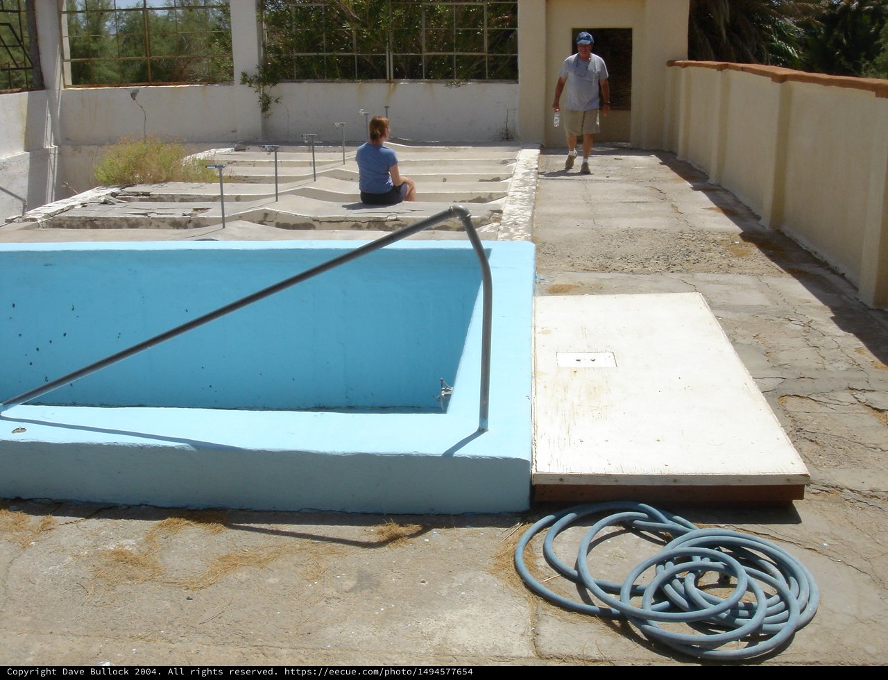 Abandoned Drained Swimming Pool Under Harsh Sunlight