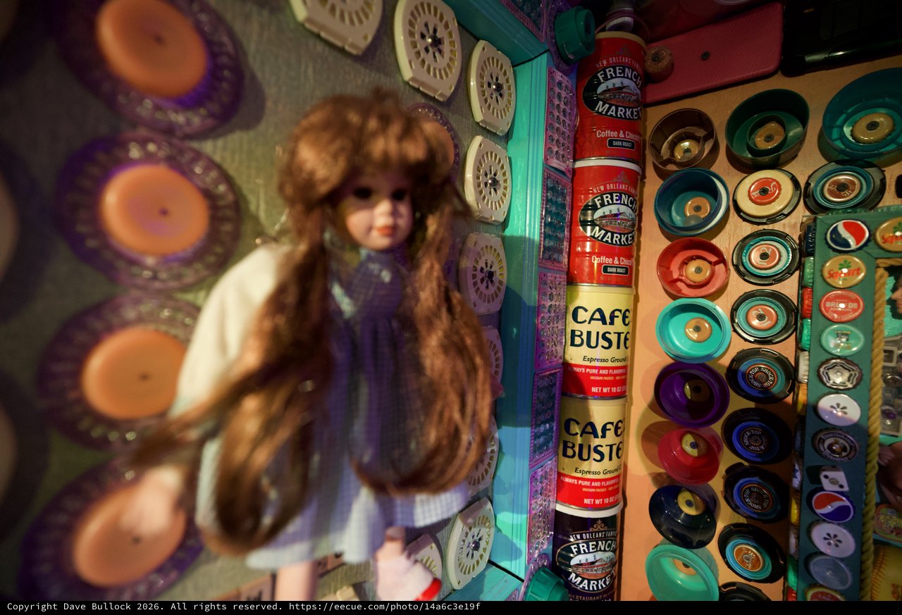 Vintage Doll Among Colorful Button Collection Display