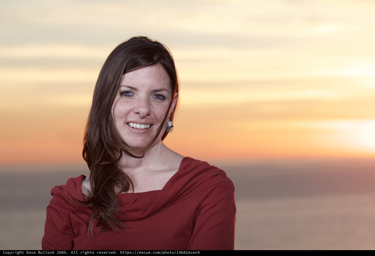 Smiling Woman in Red at Golden Sunset