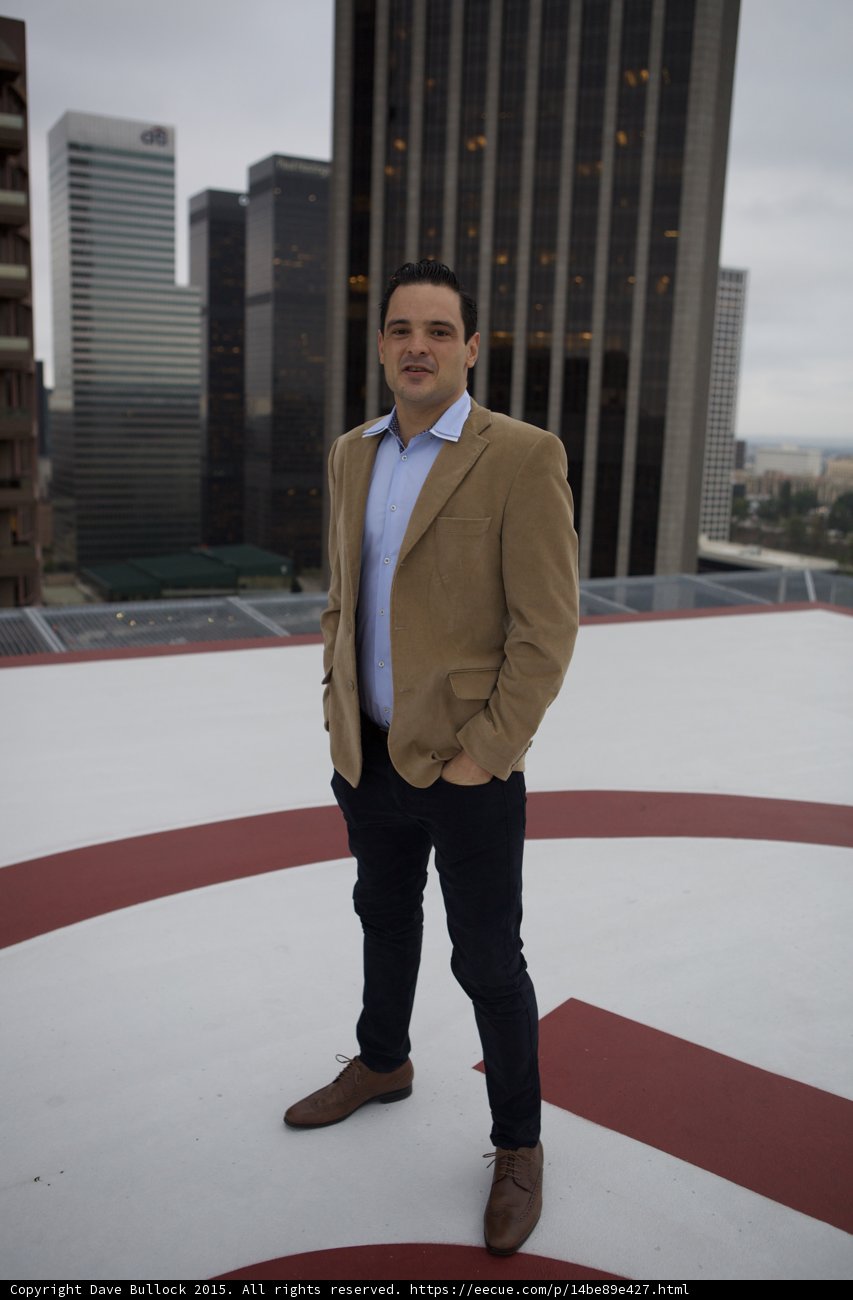 Man on a Rooftop with City Skyline View