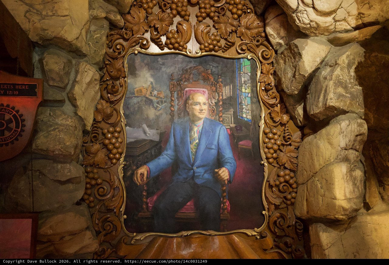 Ornate Portrait in Gilded Frame Against Stone Grotto