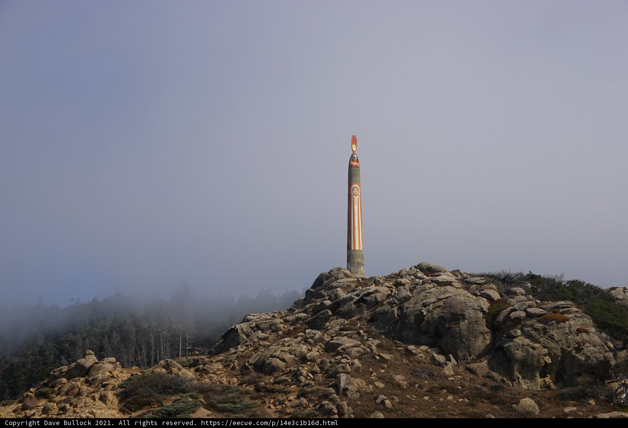 Towering Beacon amidst the Foggy Mountains