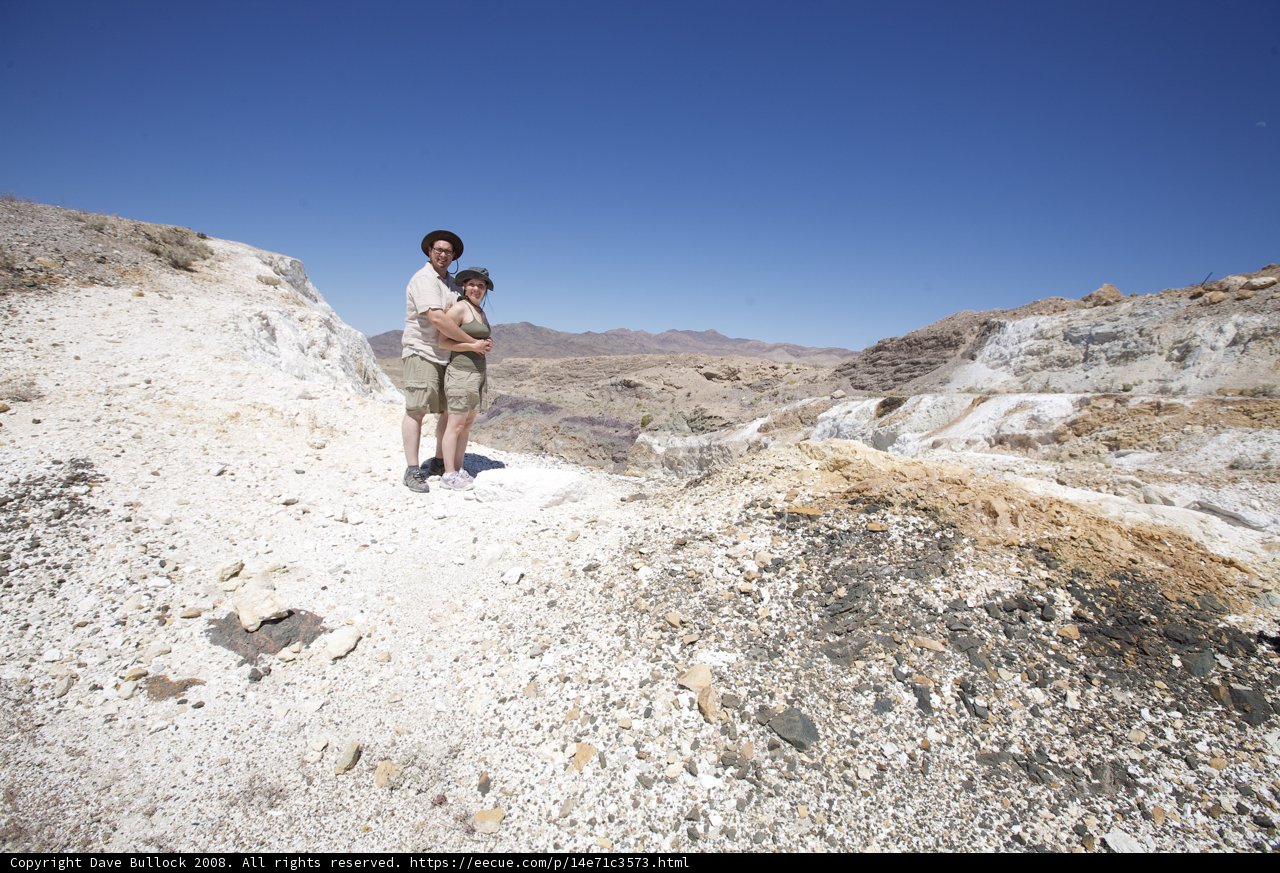 Father and son conquer rocky hill on desert adventure