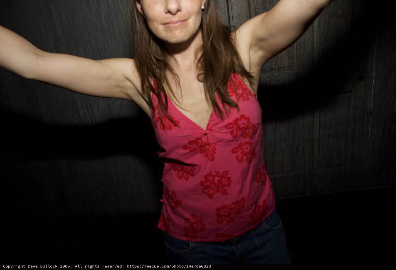 Woman Dancing Freely With Arms Outstretched at Night