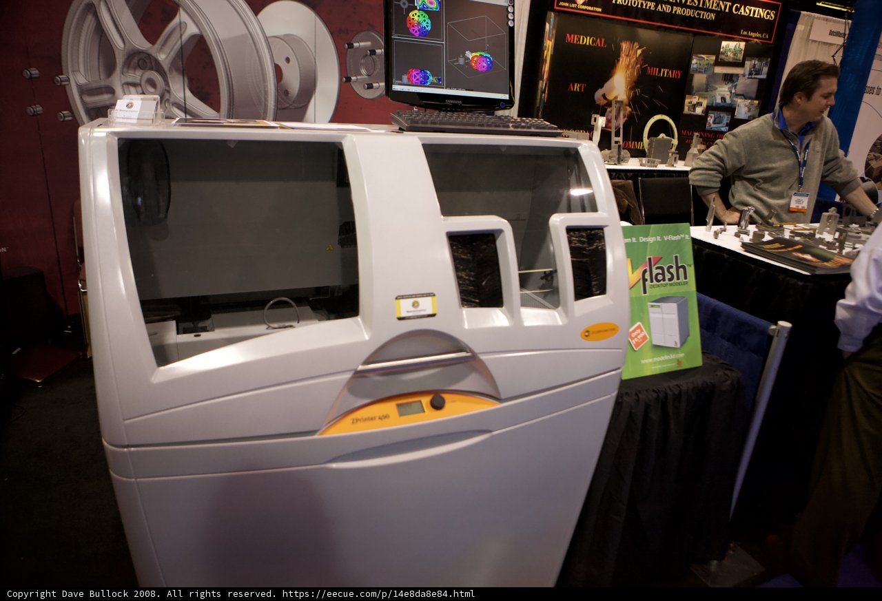 Man Stands Beside Displayed Machine at Robot Automation Show
