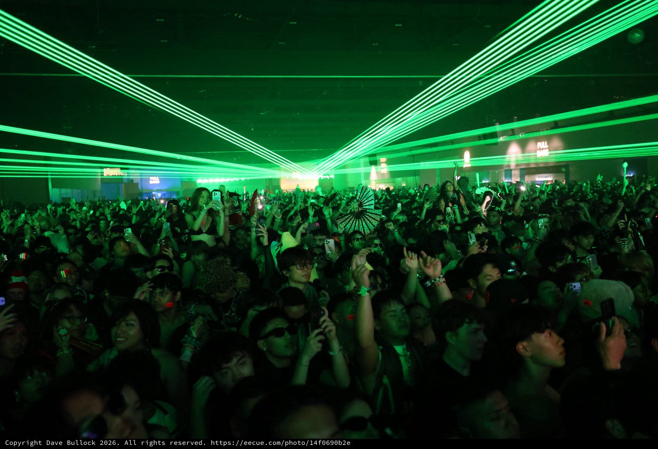 Green Laser Light Show Over Festival Dance Crowd