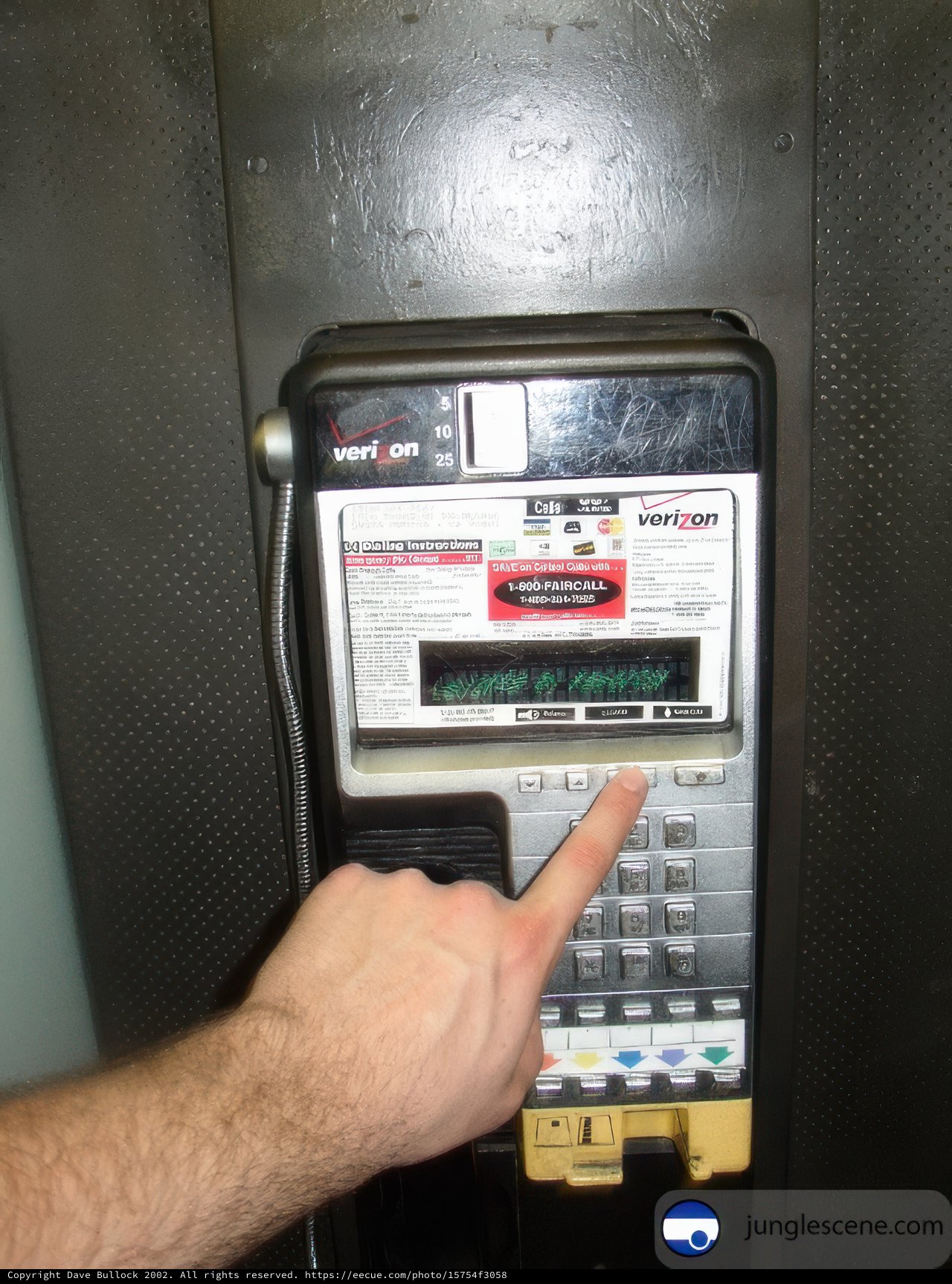 Man Touching Keypad of a Machine