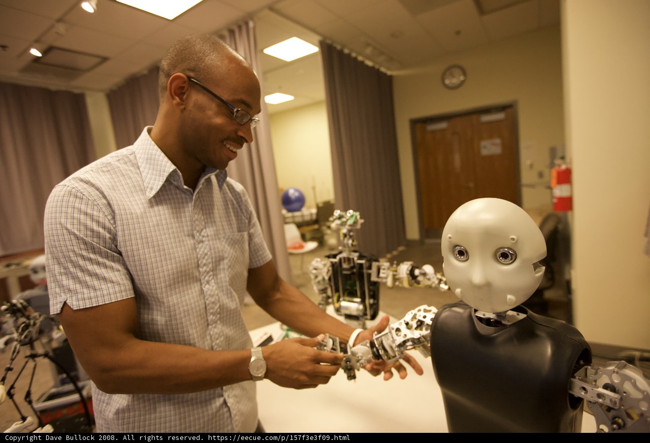 Man Holds Robot Head in His Hands