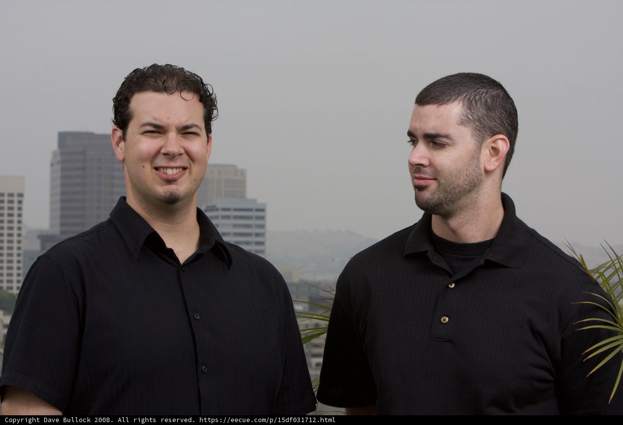 Smiling Duo Outside Skyscraper