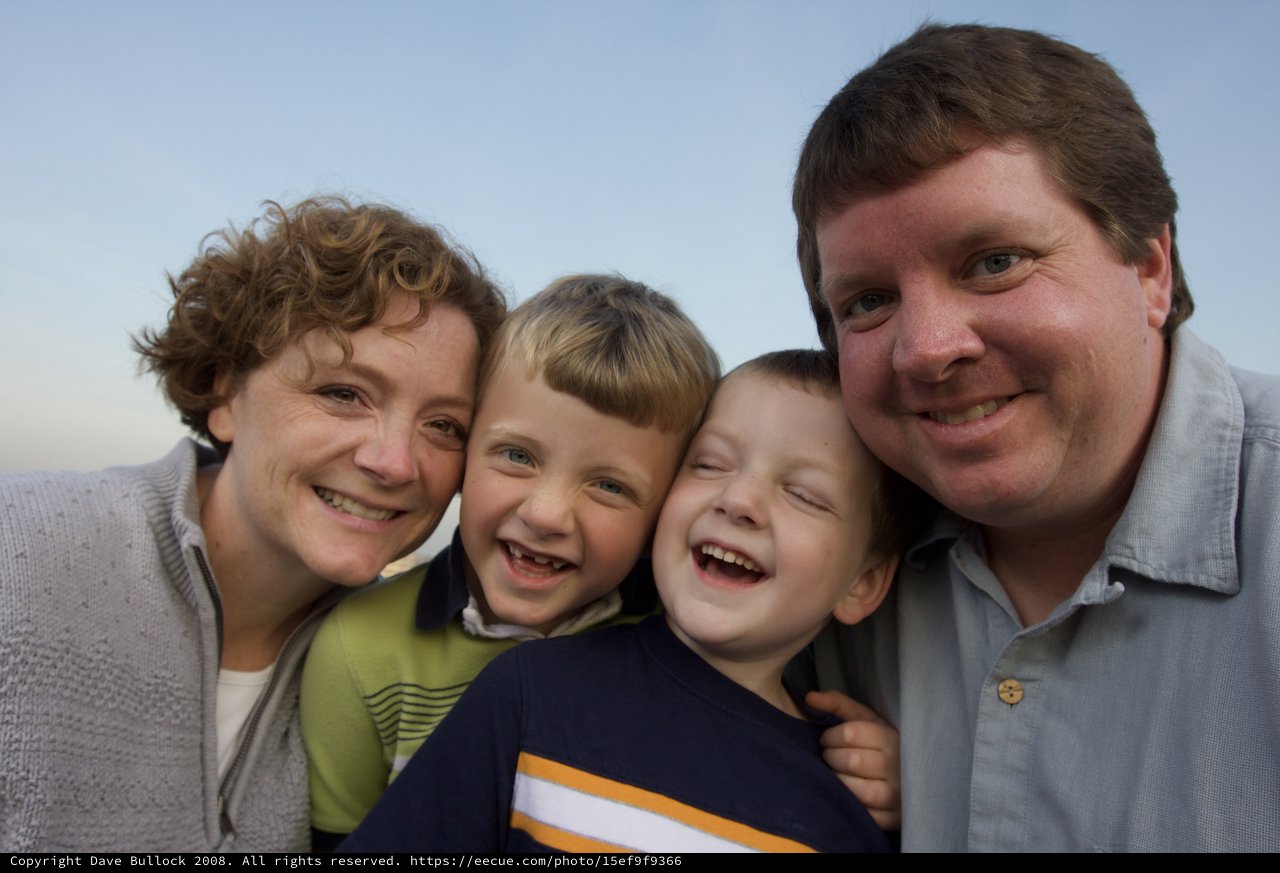 Joyful Family of Four Smiling Outdoors Together