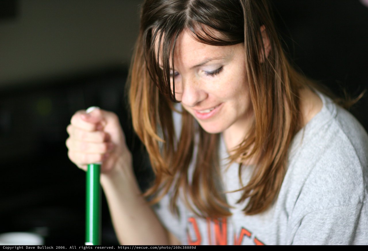 Smiling Woman Grips Green Handle with Delight