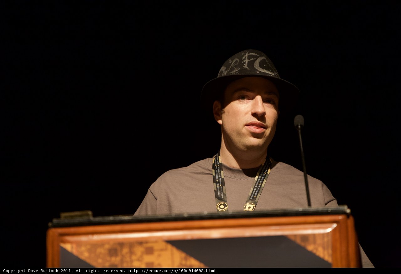 Hat-Wearing Speaker at the Podium