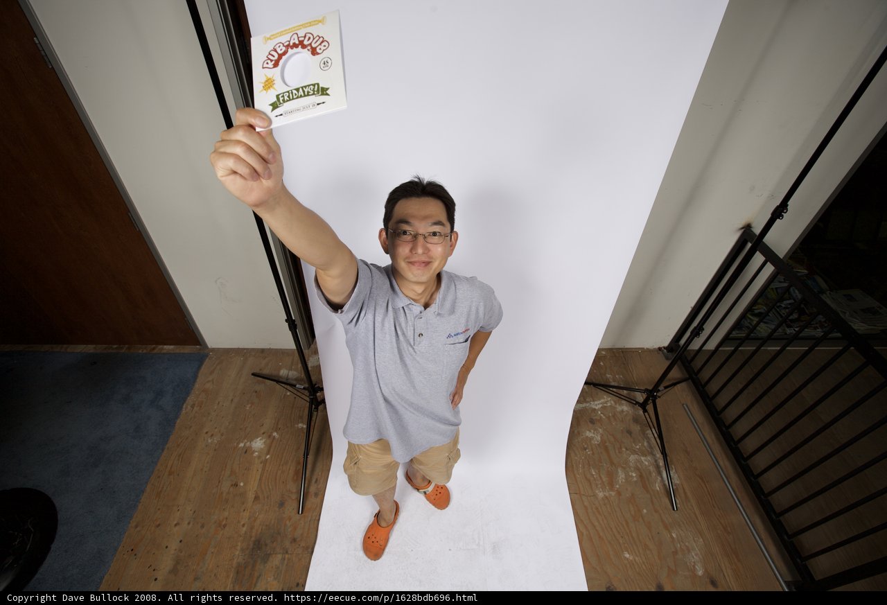Man Holding a Sign in Front of a White Backdrop