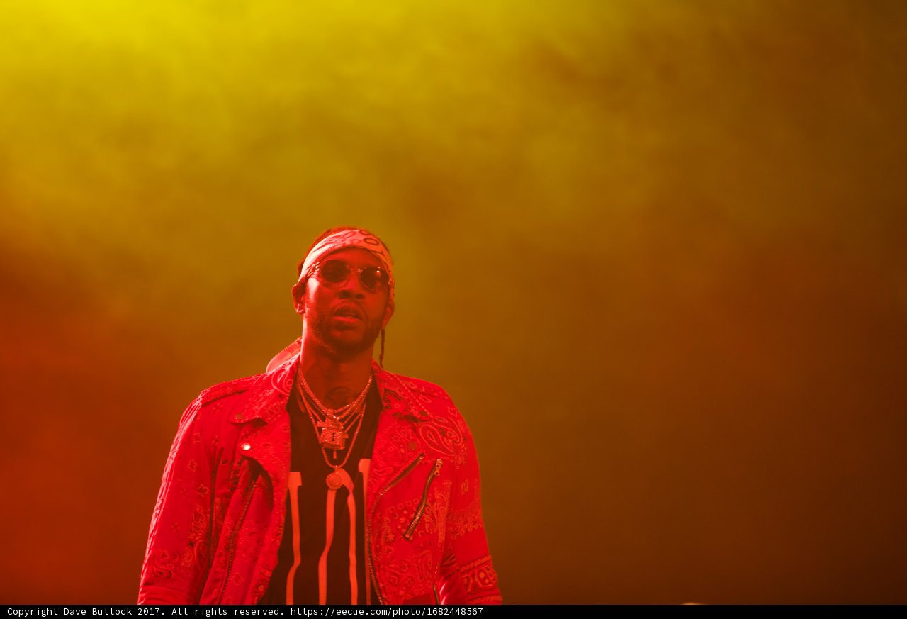 2 Chainz Rocks the Stage in Maroon Sweater and Red Jacket