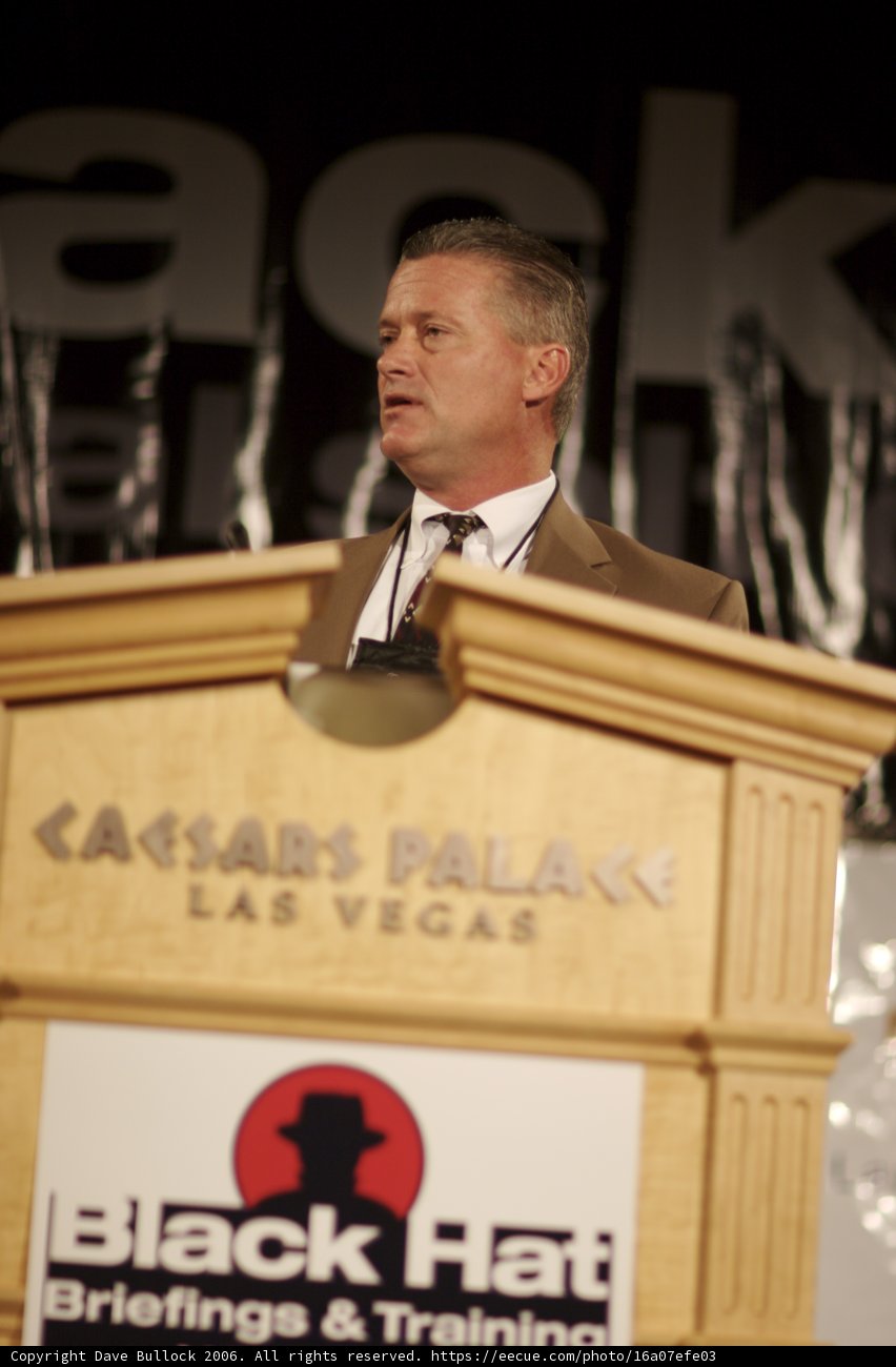 Man in Suit Delivers Speech at Plywood Podium