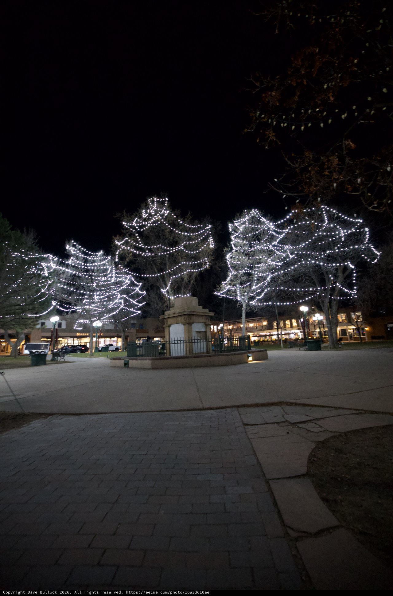 Illuminated Angel Wings Display in Town Square at Night