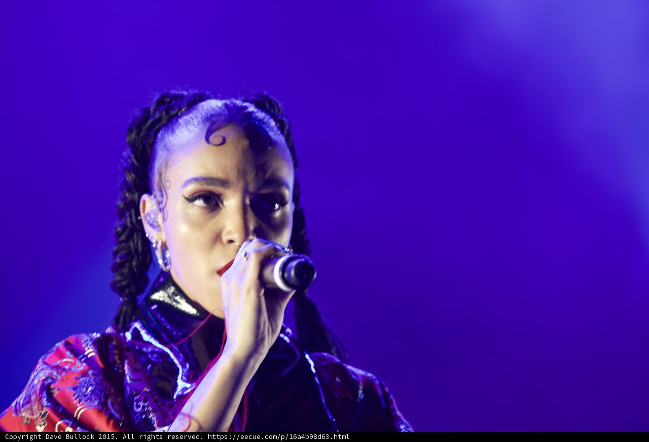 FKA twigs Stunning Close-Up Portrait Direct Gaze Baby Hairs Swirls Cat-Eye Makeup Multiple Earrings Septum Ring Red Lipstick Black Choker Braided Ponytails Kimono Purple Blue Lighting