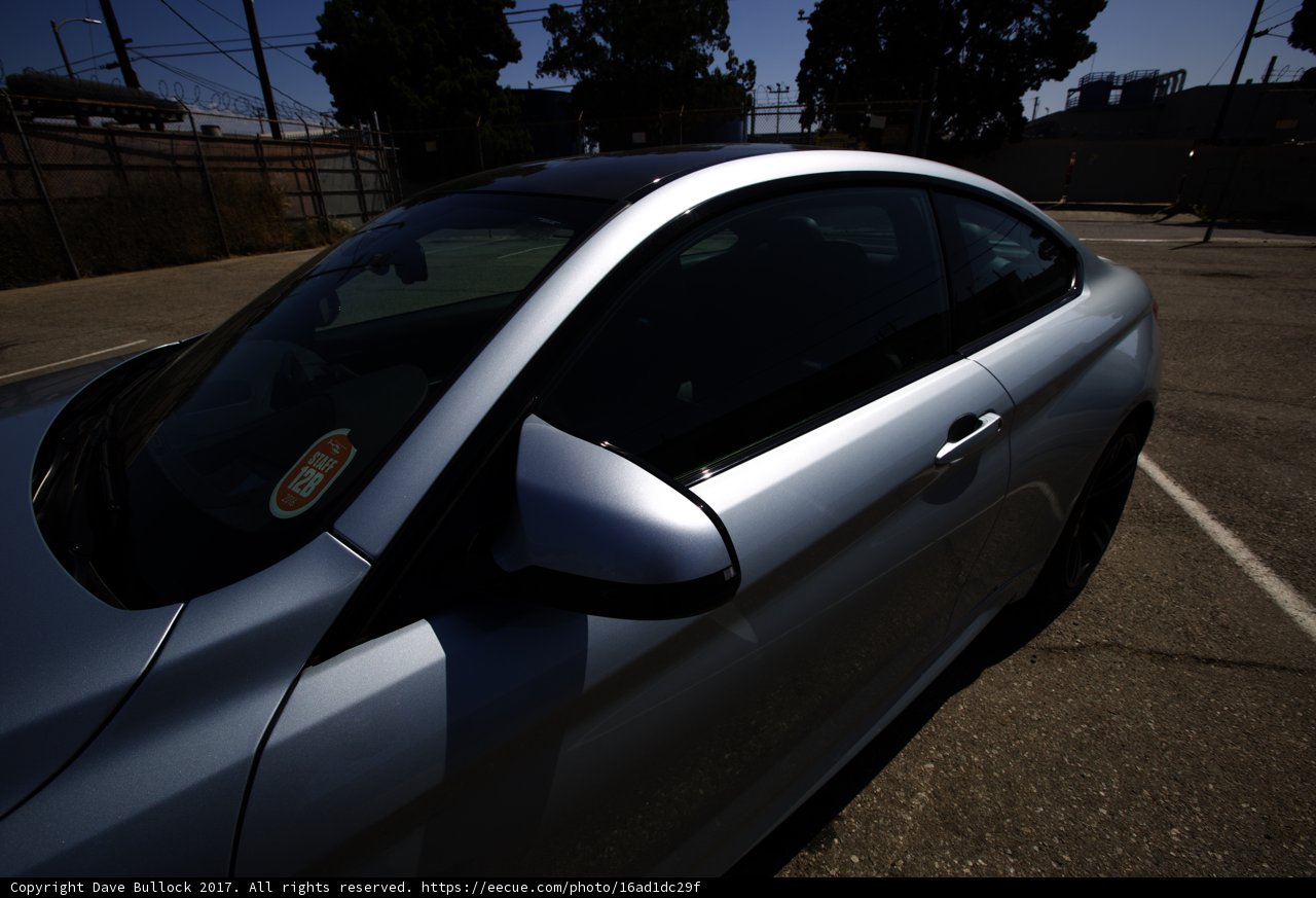 A sleek sports car parked under the blue sky
