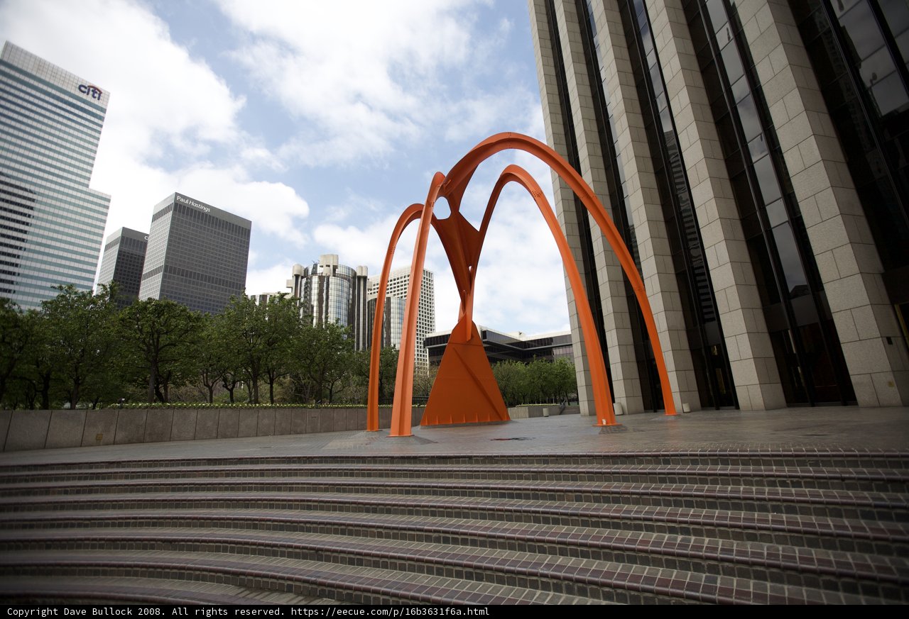 Orange Arch Against Urban Skyline