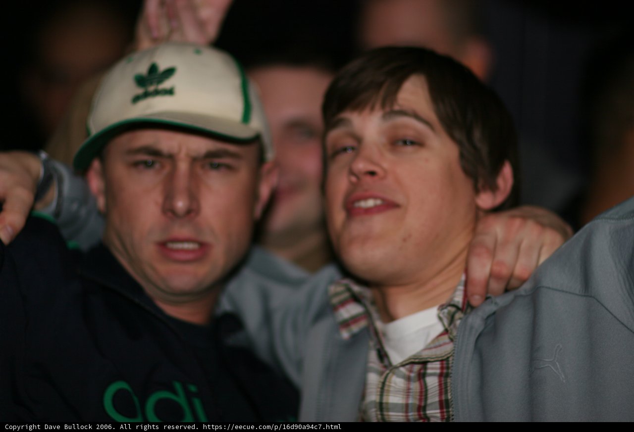 Two Men Strike a Pose in Baseball Caps