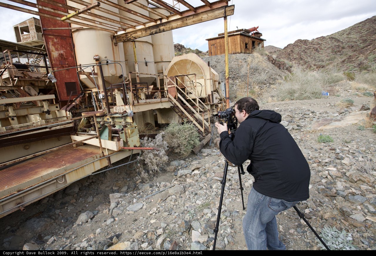 Man photographing a factory machine