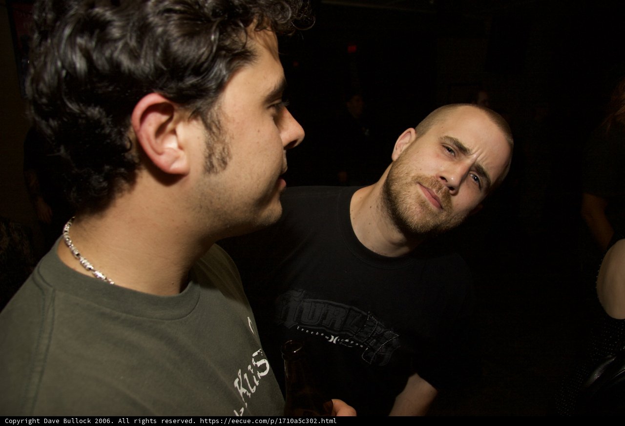 Two Men in T-Shirts at a Night Club