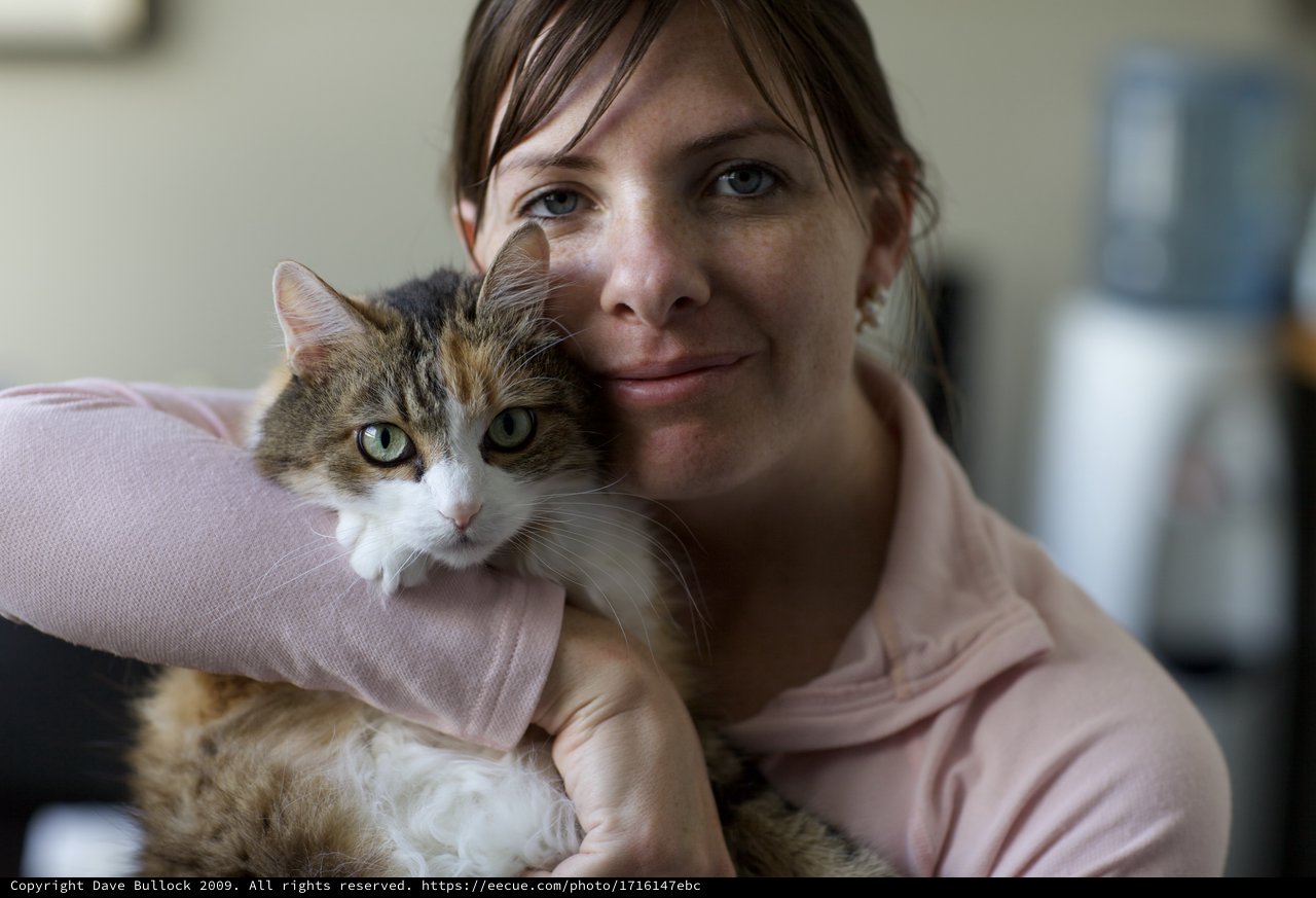 Woman and Calico Cat Share a Tender Moment