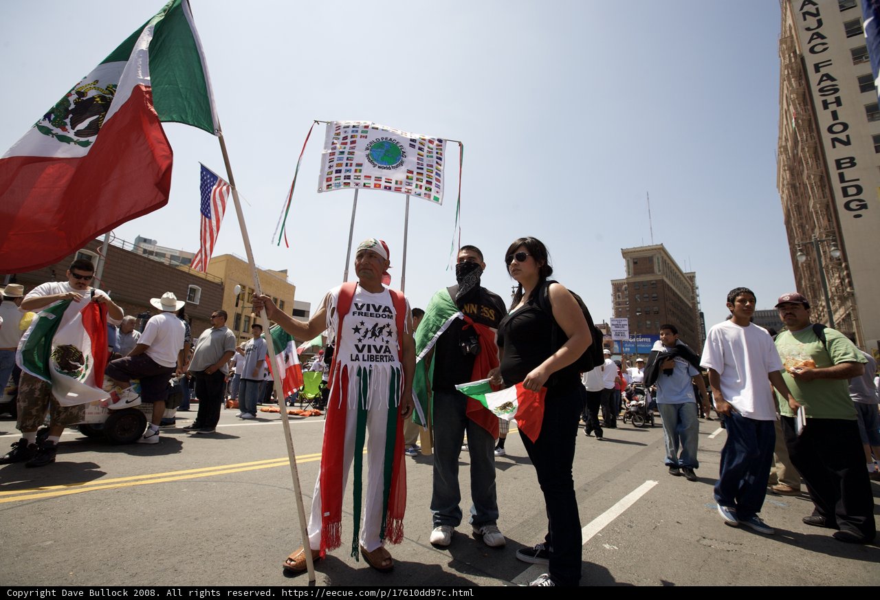 Man Proudly Holds Mexican Flag at Mayday Rally