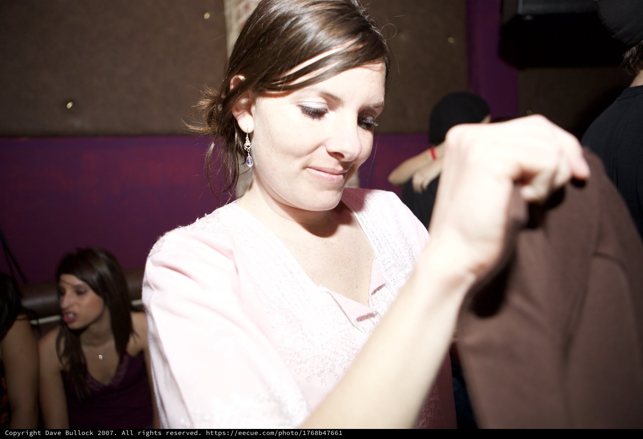 Woman Dancing at Dimly Lit Nightclub Event