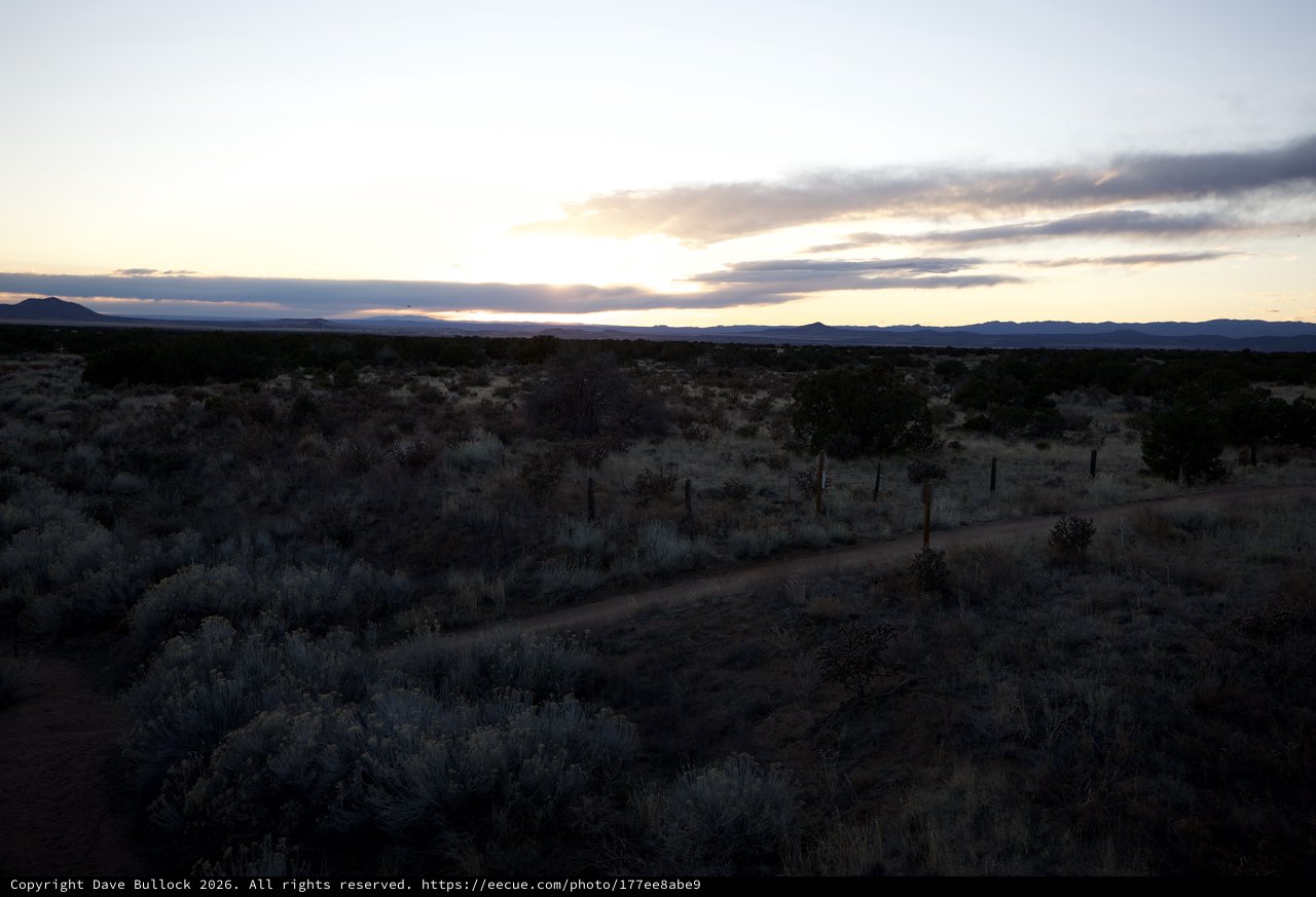 Desert Twilight Along a Fence-Lined Dirt Road