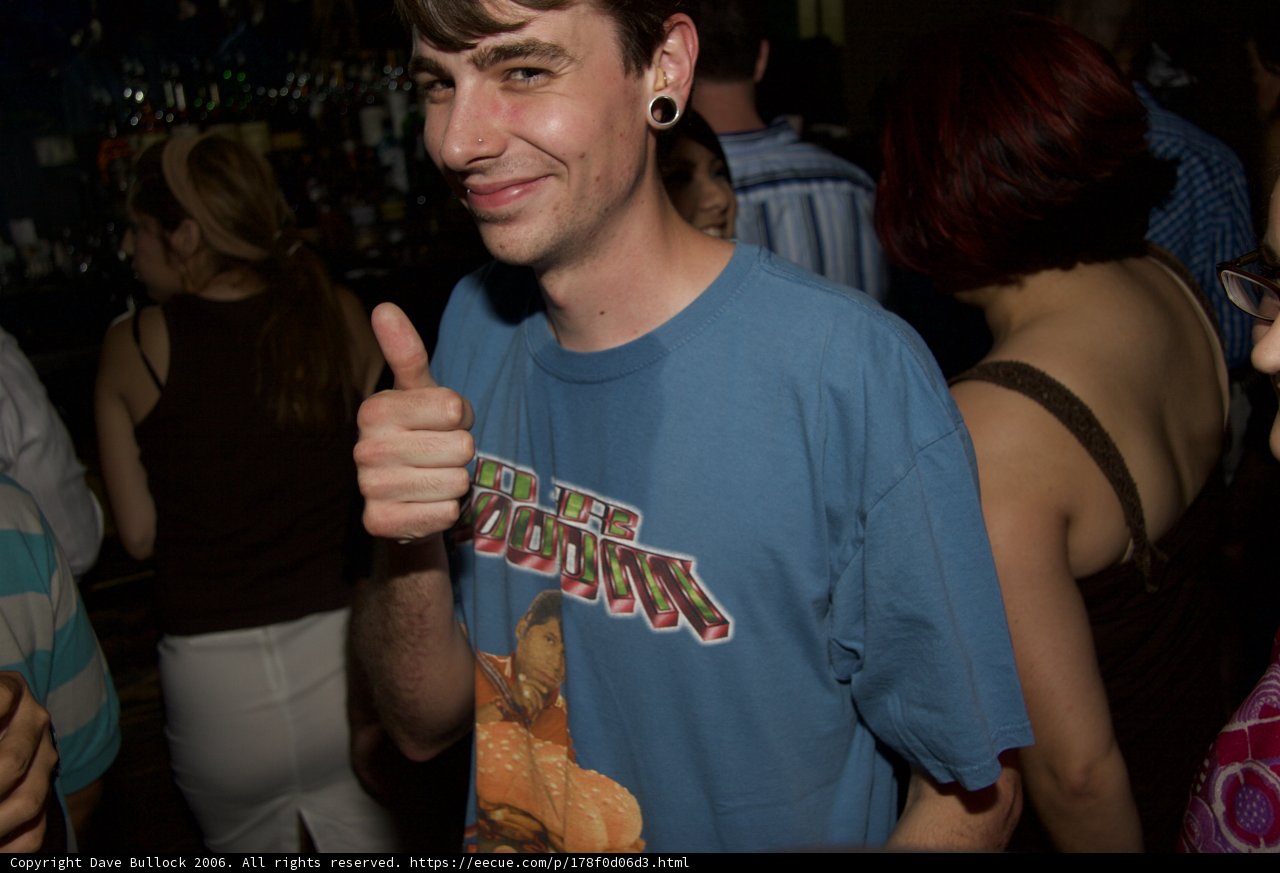Blue Shirted Man Enjoys Night Out with Friends